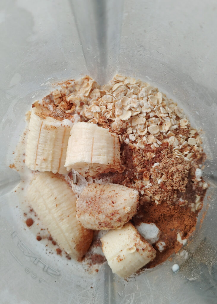 ingredients for oat banana pancakes added to a blender