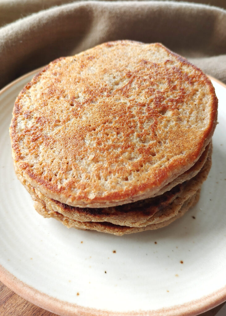 oat banana pancakes stacked without toppings in a plate
