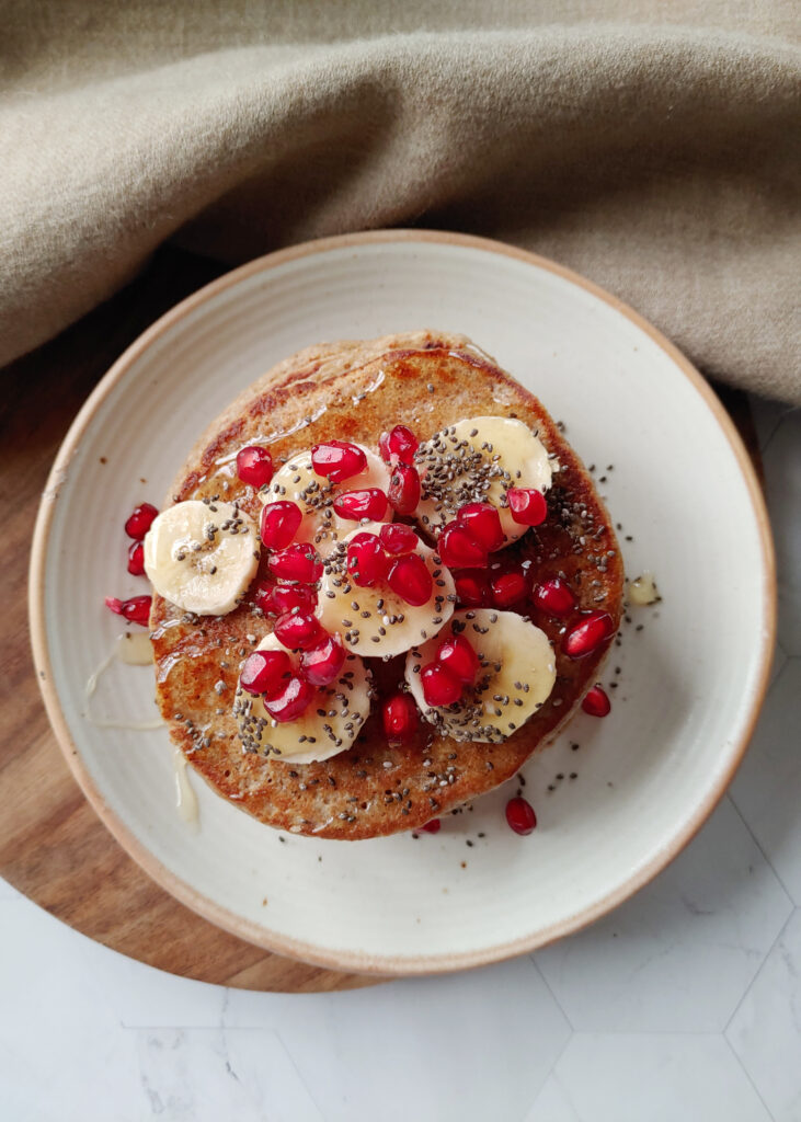 oat banana pancakes  with toppings in a plate