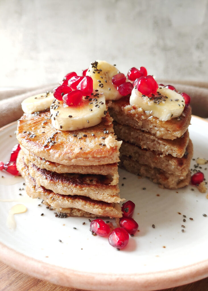 sliced oat banana pancakes with toppings in a plate