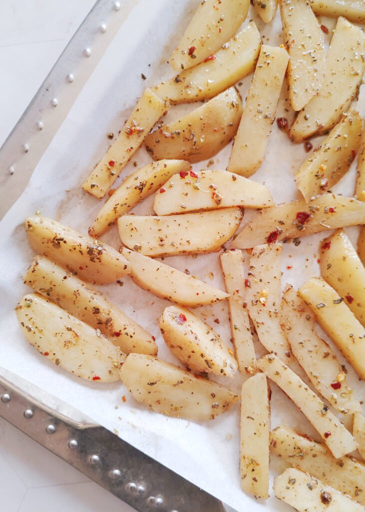 potato wedges in a tray before baking zoomed in photo