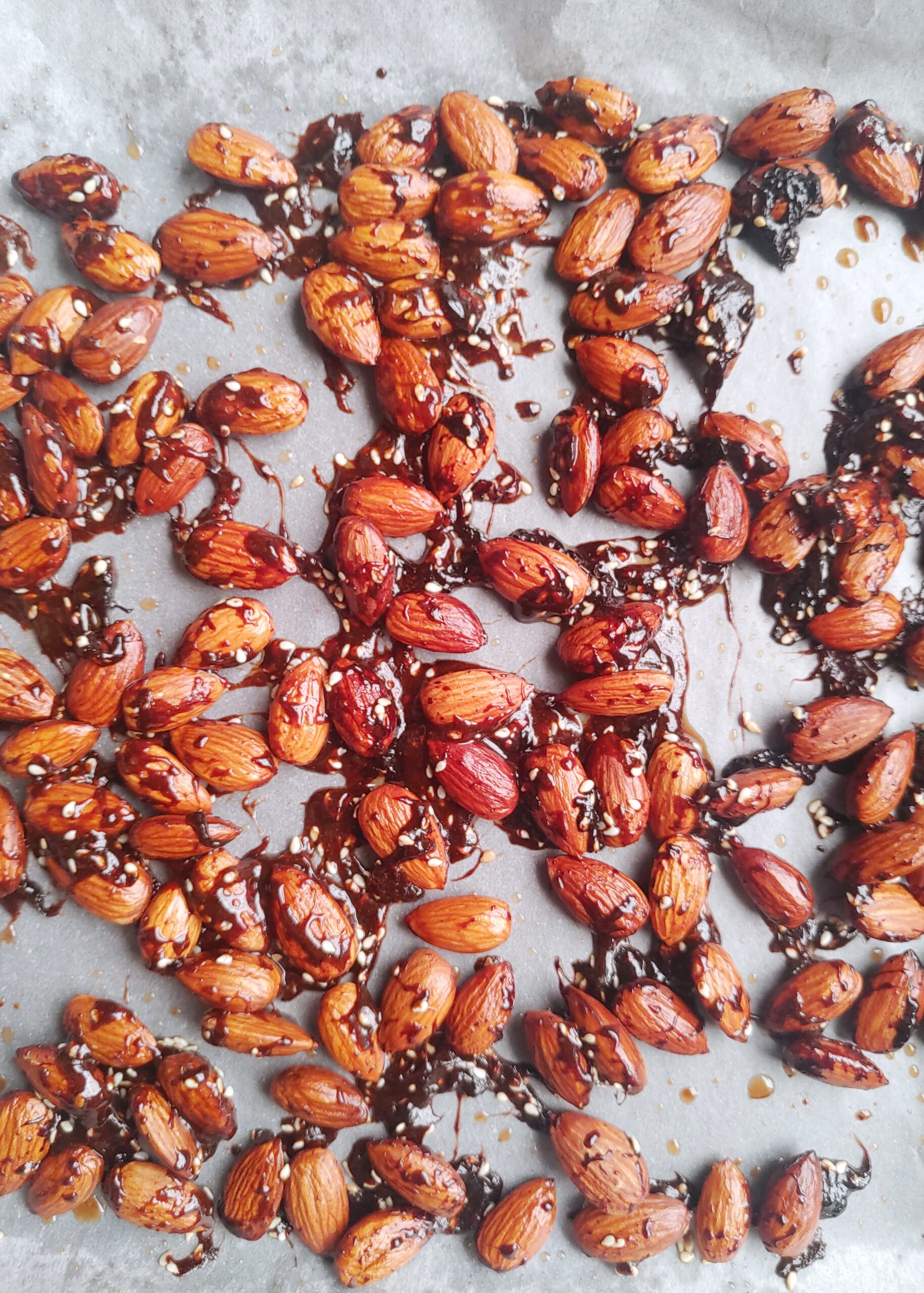 candied sesame roasted almonds close look on baking tray