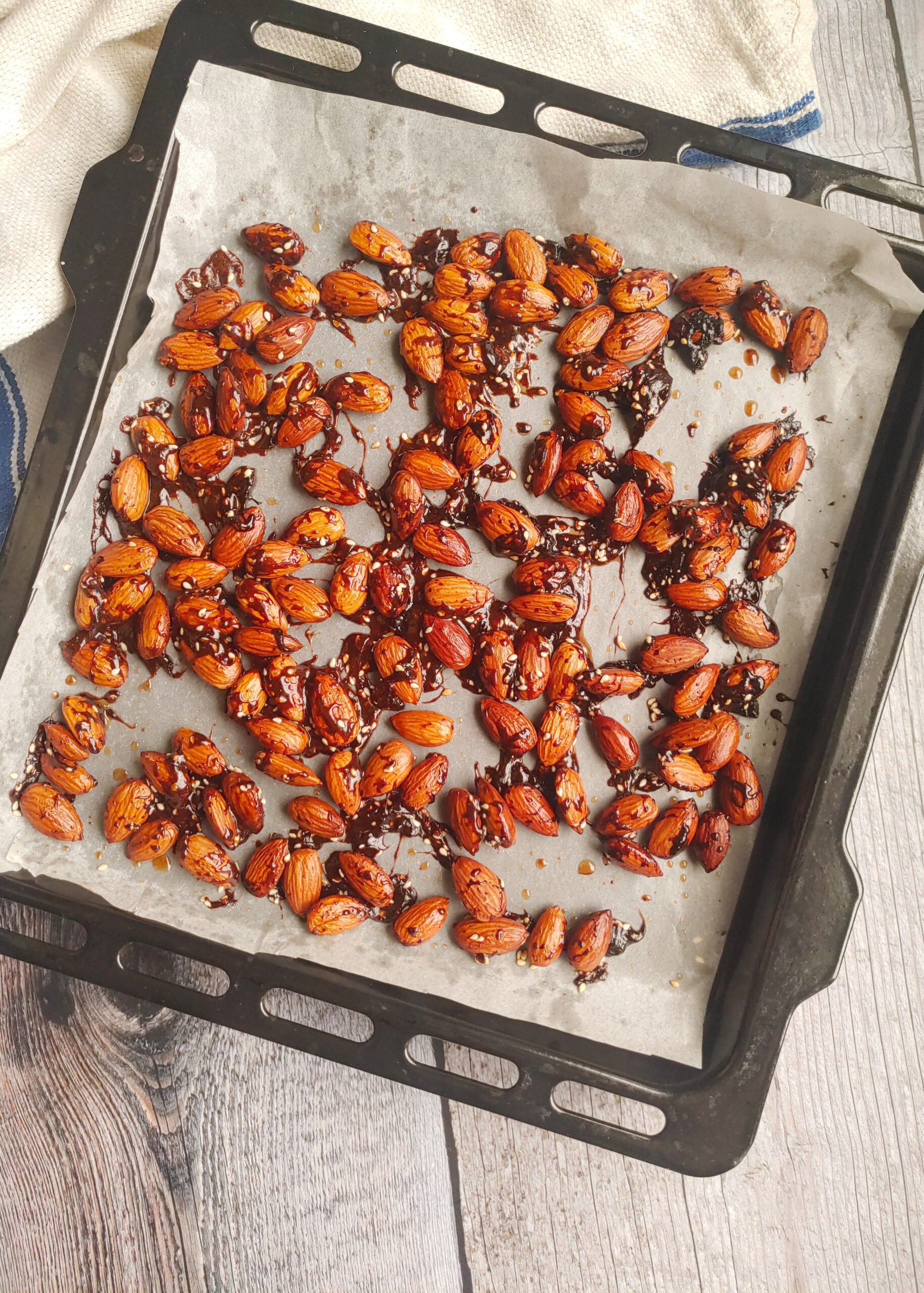 candied sesame roasted almonds on a baking tray