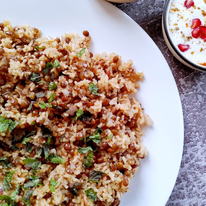 one pot lentil rice in a plate with mint chutney and raita