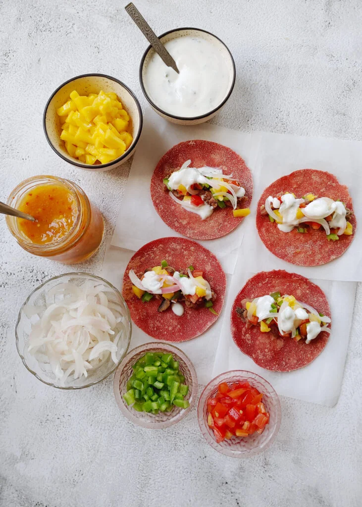beet tacos with bean and mushroom filling, topped with yoghurt and veggies