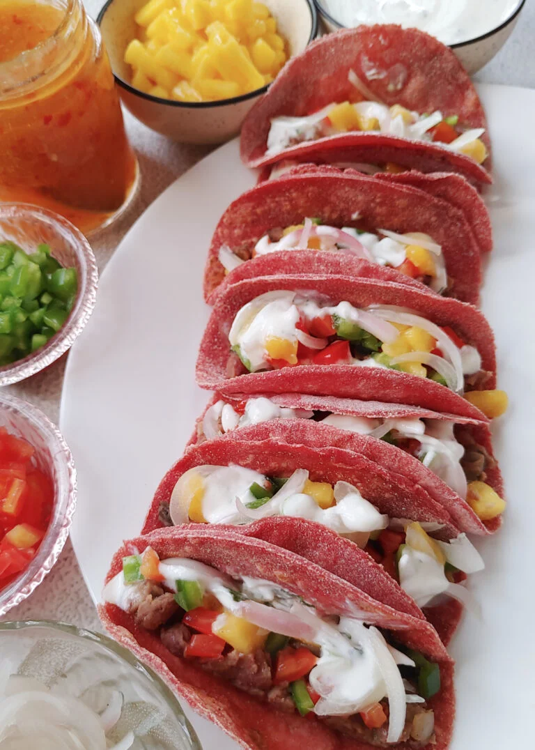 beet tacos with bean and mushroom filling, topped with yoghurt and veggies