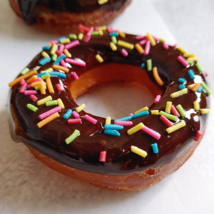 chocolate eggless donut with rainbow sprinkles