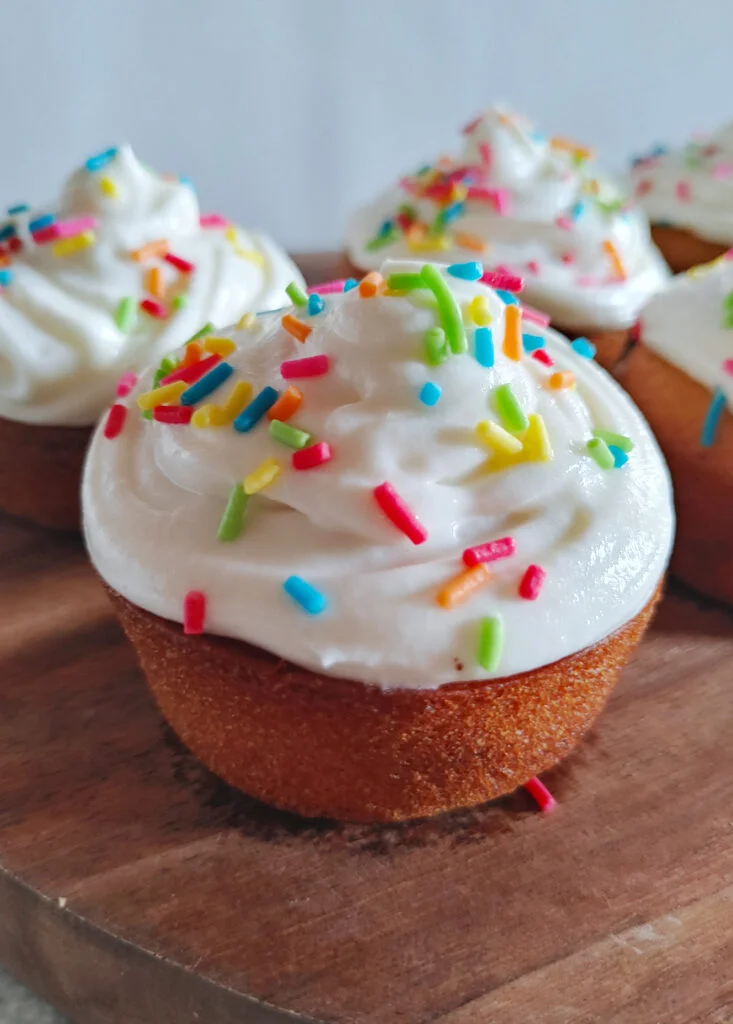 eggless vanilla cupcake with buttercream frosting and rainbow sprinkles photo