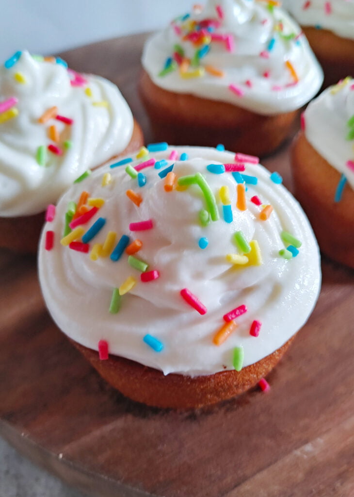 eggless vanilla cupcake with buttercream frosting and rainbow sprinkles