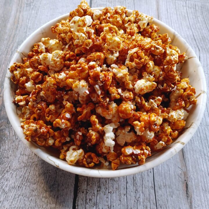 caramel coated popcorn served in a bowl
