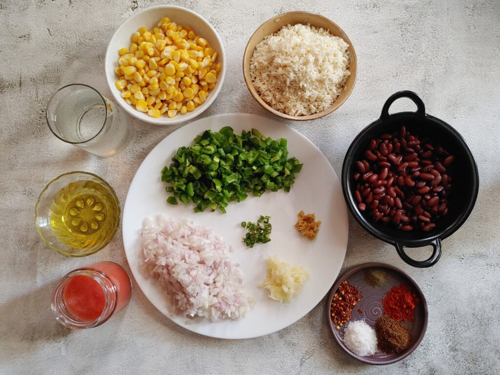 mexican inspired vegan beans and rice recipe ingredients in plates and bowls placed on a table
