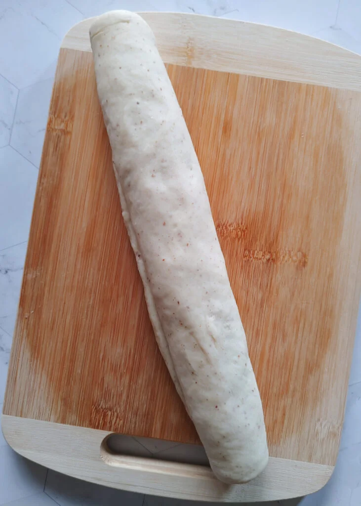 cinnamon roll cookies dough with cinnamon and brown sugar filling rolled into a log shape