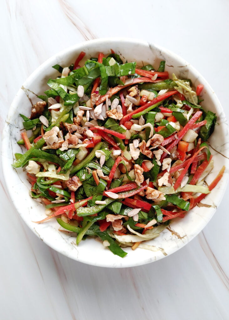 carrot and mixed greens salad served in a bowl