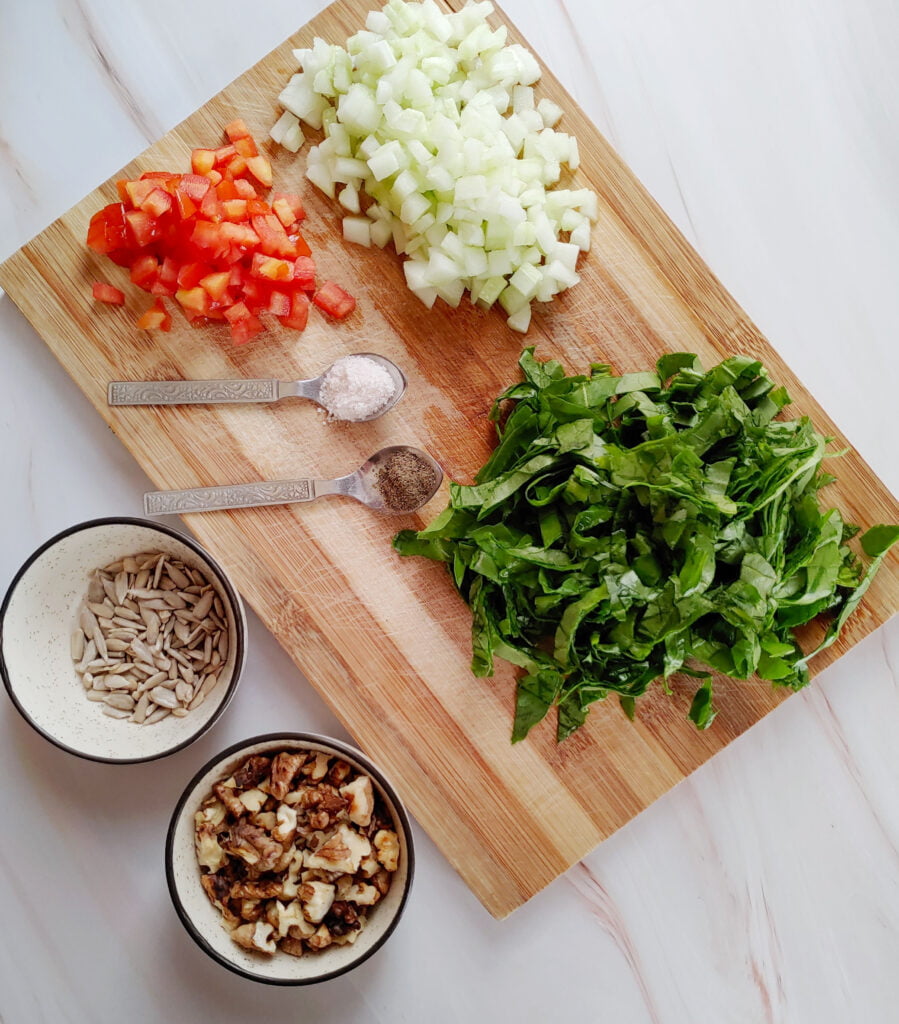 chopped spinach cucumber tomatoes roasted walnuts roasted sunflower seeds salt and ground black pepper