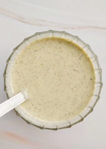 featured image oil - free roasted pumpkin seed dressing served in a glass bowl