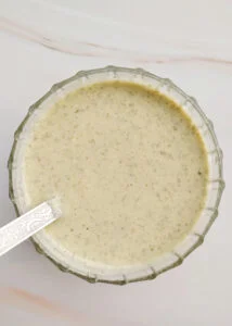 featured image oil - free roasted pumpkin seed dressing served in a glass bowl