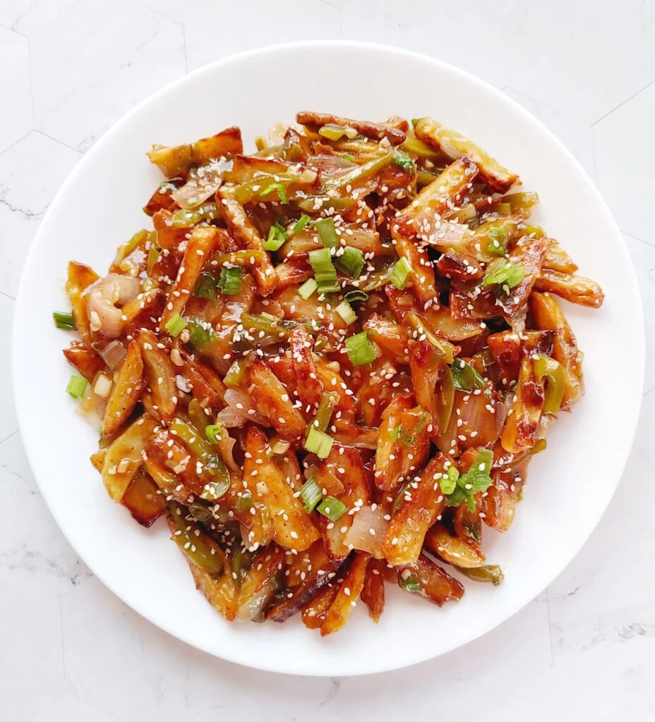 honey chilli potatoes served in a plate