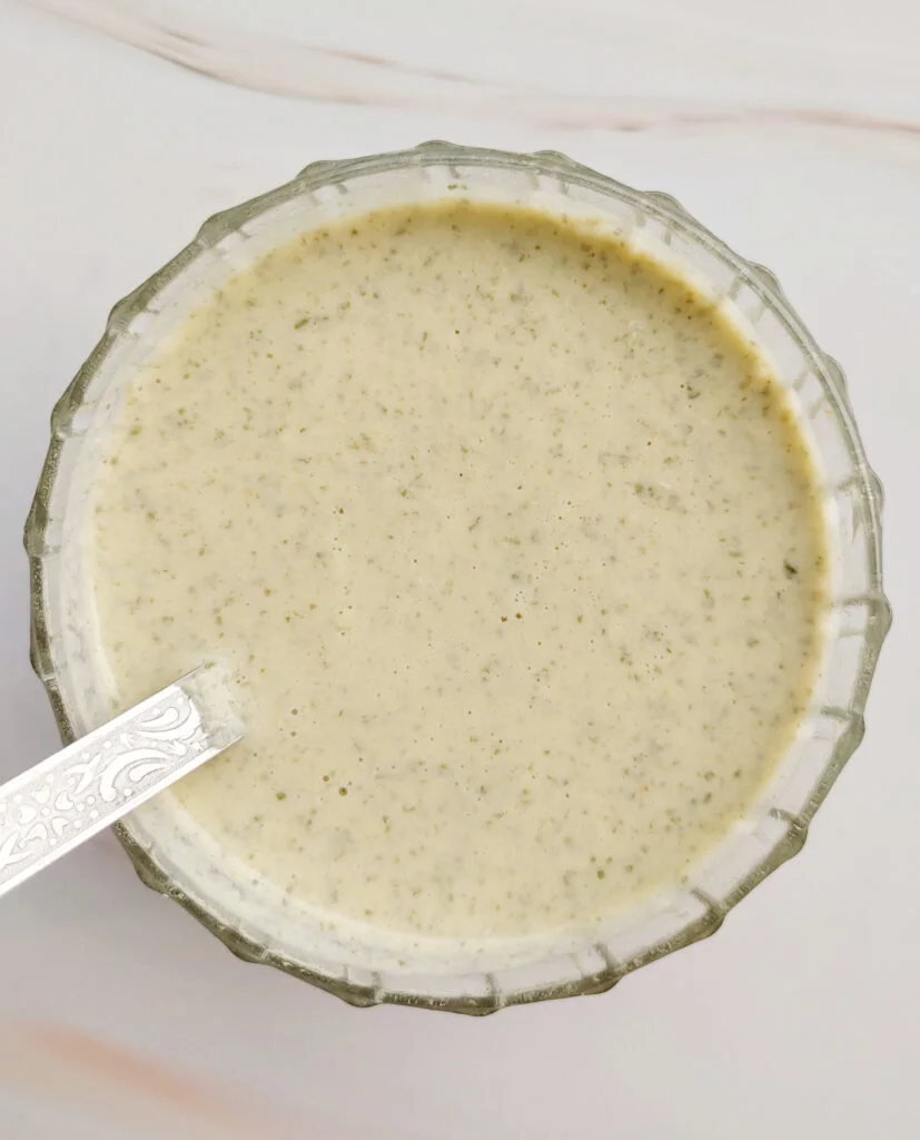oil - free roasted pumpkin seed dressing served in a glass bowl photo taken from the top