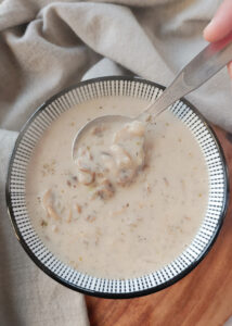 creamy mushroom soup in a bowl with spoon