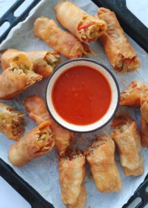 vegetable spring rolls served with a dipping sauce