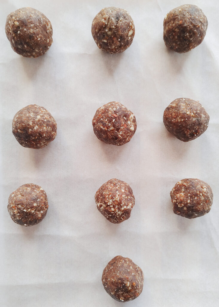 healthy chocolate truffles rolled into balls before chocolate coating and placed on a platter