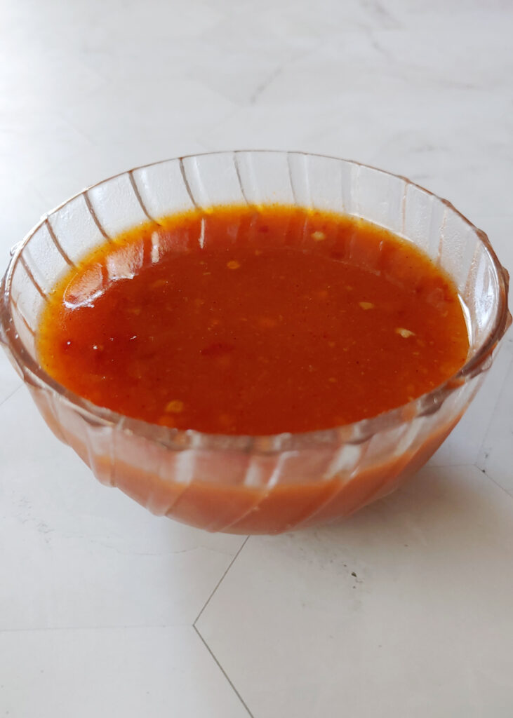photo taken from side of spring rolls dipping sauce served in a bowl