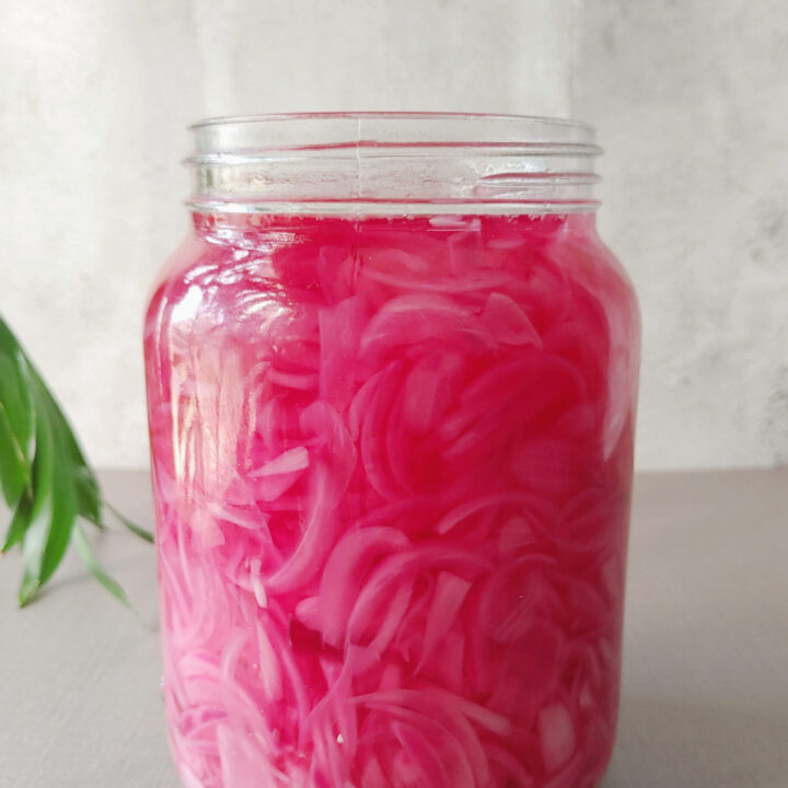 pickled red onions in a glass jar