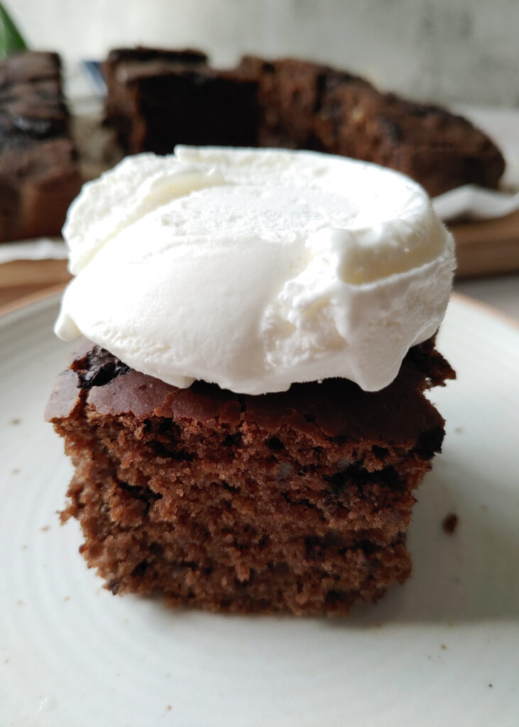 a piece of brownie served with ice cream