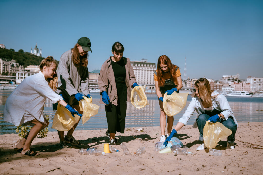 group of people collecting plastic waste at beach