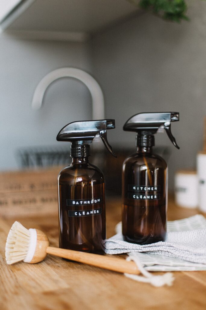 homemade cleaners in two glass spray bottles