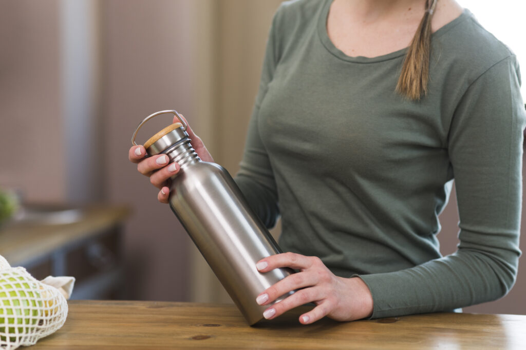 woman holding a stainless steel water bottle