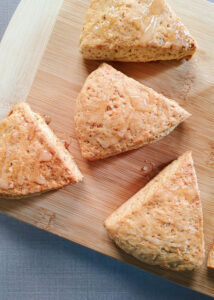 zoomed in photo of baked scones on a wooden board