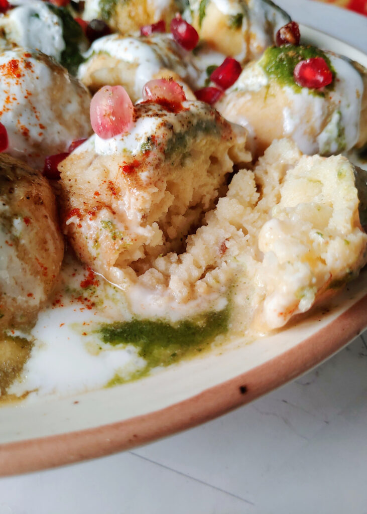 dahi bhalla in half served in a plate