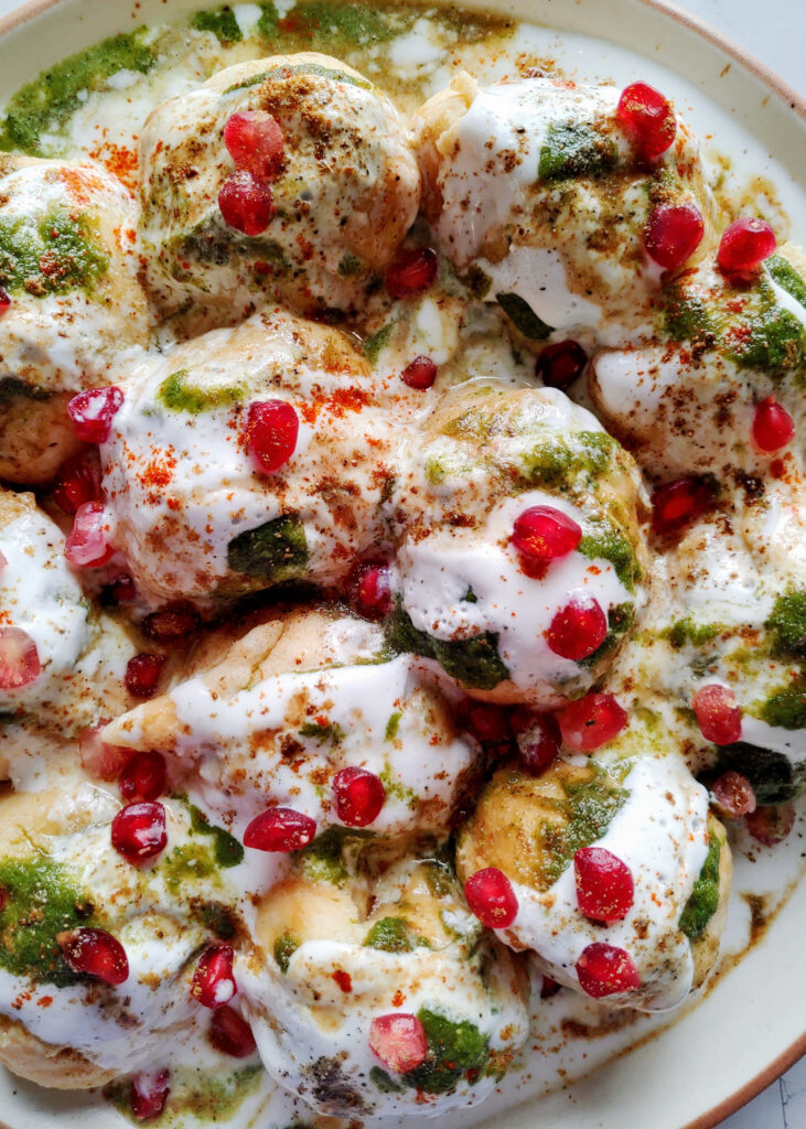 zoomed in photo of dahi bhalle served in a plate