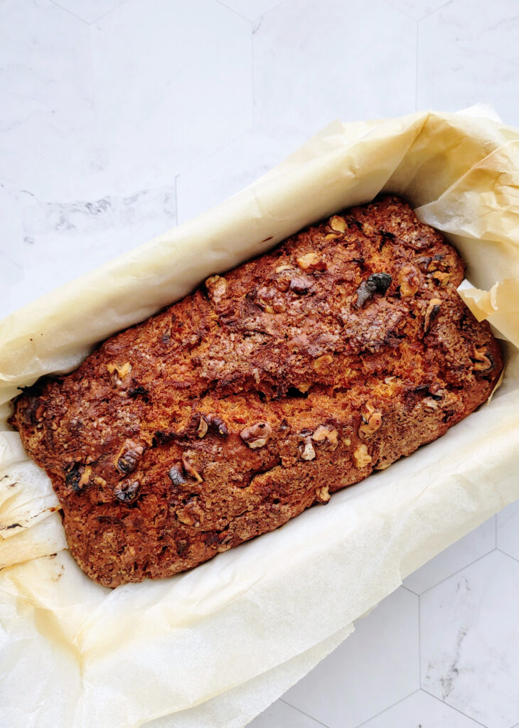baked eggless carrot walnut bread in a loaf tin