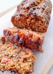 featured image of sliced eggless carrot walnut bread on a wooden board