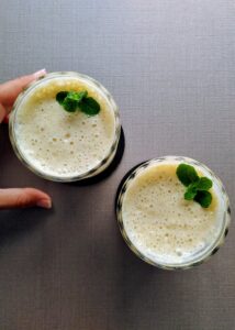 photo taken from top of pineapple smoothie in two glasses featured image