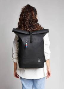 a girl with a GOT backpack on her back for featured image on 7 best eco-friendly backpacks sustainable brands